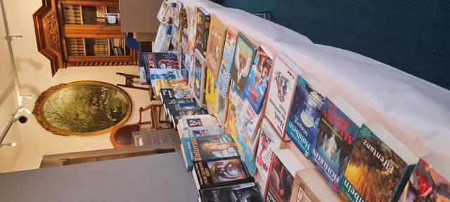 Beim Bücherflohmarkt im Stadtmuseum liegen zahlreiche bunte Romane, Sachbücher und Kinderbücher auf langen Tischen zum Stöbern aus.