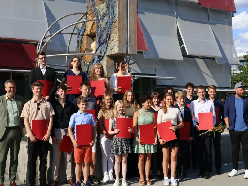 Eintragung in die Ehrenchronik der Stadt Cottbus am 16. Juli 2024 – Gruppenfoto der Geehrten mit Urkunden vor dem Gründungszentrum Cottbus